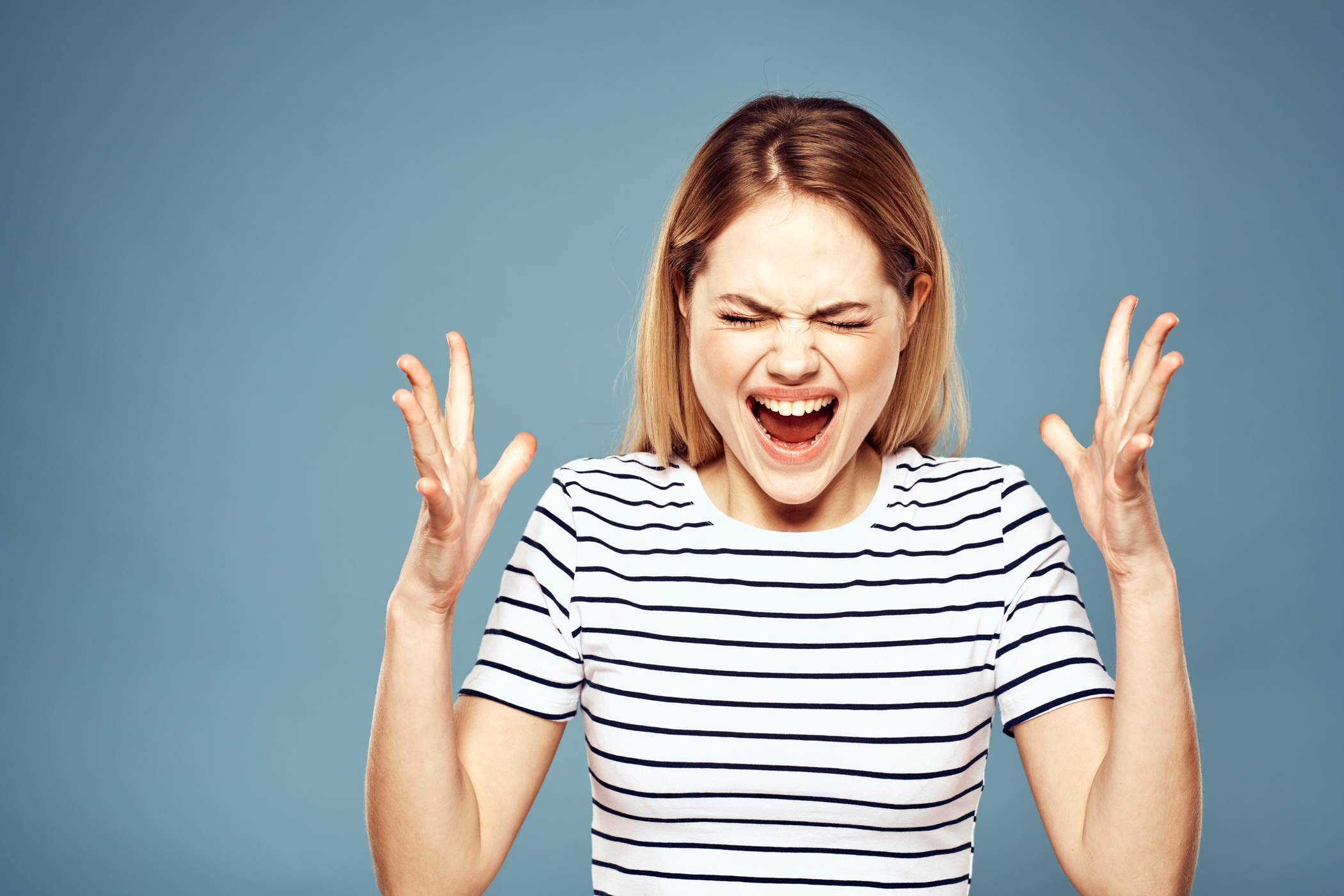 Upset Woman Emotions Displeasure Gestures with Hands Blue Background